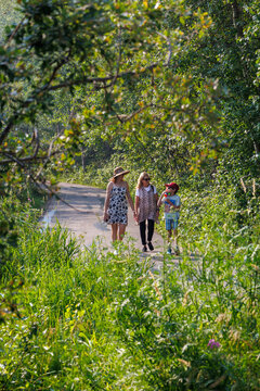 Family walking along a trail in a park