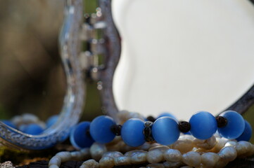 A jewelry box and various decorations. Necklace, beads.