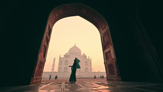A woman in an Indian sari dancing in slow motion at the Taj Mahal, India