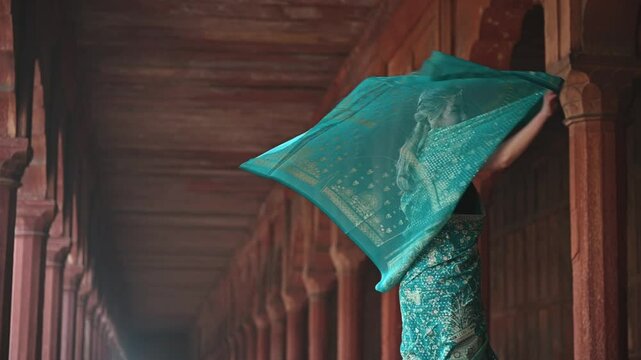 A woman in an Indian sari dancing in slow motion