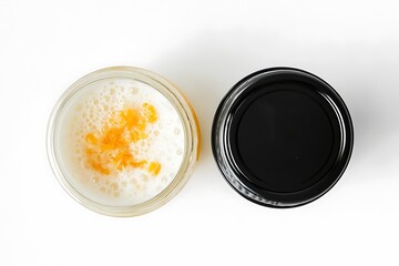Two small glass jars, one filled with frothy white beer and the other with refreshing orange juice.
