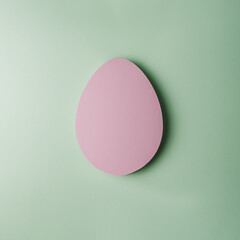 Blank pink egg-shaped mockup on pastel green background, perfect for Easter designs, greeting cards, and creative decorative concepts