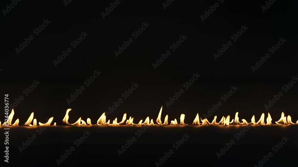 Poster small flames dancing and creating a fiery line against a dark backdrop, offering a striking and visu