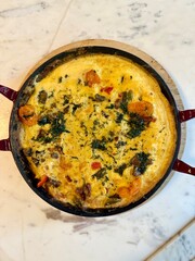 Italian Frittata made with spinach, tomatoes, onion and peppers