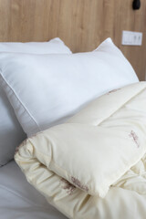 White pillows and blanket on the bed. Close-up