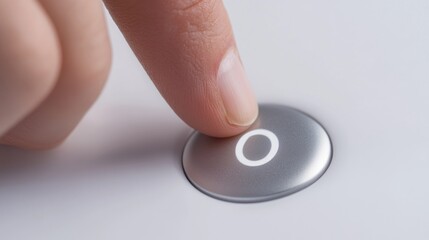 A close-up shot of a finger pressing a button on a white surface