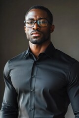 Fototapeta premium A man wearing glasses and a black shirt, suitable for various professional or academic settings