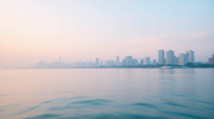 Calm Waters and Soft Skies Over a City Skyline at Sunrise