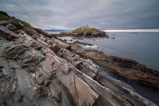Dramatic Coastal Lighthouse on Rocky Cliffs of Northern Spain