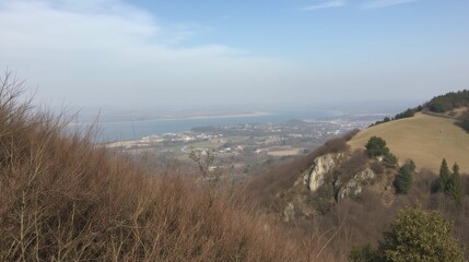Fototapeta premium Scenic View of Landscape with River and Mountains from Hilltop