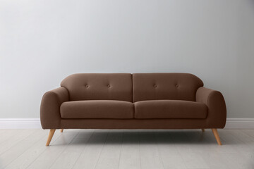 Sofa in mocha mousse shade indoors. Interior with trendy color of 2025 year