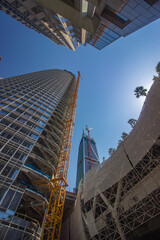 Skyscrapers under construction in San Francisco with cranes and modern architecture reaching towards the sky.