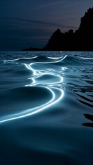 Glowing waves on a night beach under a dark sky