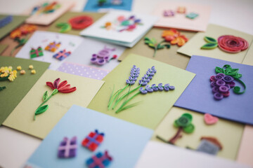 different quilling cards. making greeting cards. Beautiful flowers designs. Paper quilling, colorful paper. Hand made of paper quilling technique. Handicraft at home. Hobby, home office.