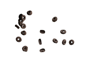 Chocolate rings cereal spill out into a bowl. Breakfast.