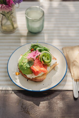 Sandwich with avocado and salmon on a brioche bun