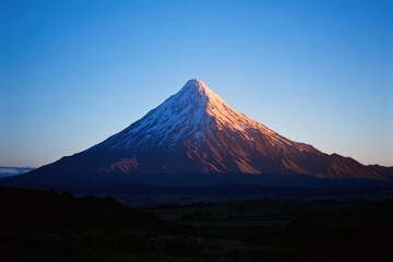 Mountainous scenery with a distant snow-covered peak, suitable for winter-themed designs or outdoor adventures