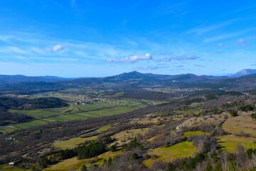 Plains with fields and forests with Vremščica hill in the background in Notranjska, Slovenia