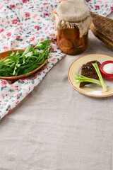 Rustic Russian-Style Food Display with Linen Tablecloth, Pickles, and Fresh Greens