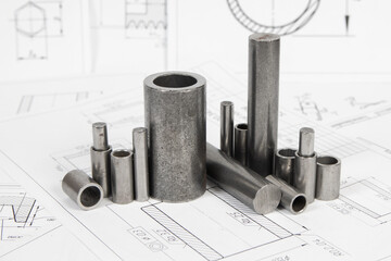 Mechanical engineering and metalworking. Metal parts rollers and bushings on engineering drawings background	
