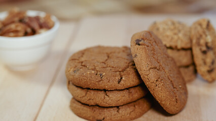 chocolate chip cookies with pecan on a wooden table close up