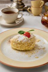 Elegant Napoleon Pastry with Mint and Strawberry Garnish in Warm Earthy Tones