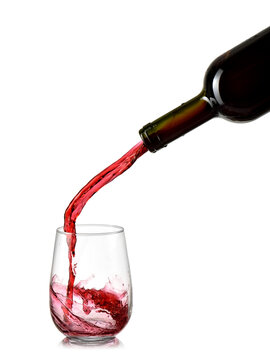 Red wine pour in a stemless glass, close up on white background, studio shot