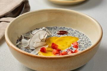 Quinoa Porridge in Coconut Milk with Mango and Coconut Slices - Minimalistic and Vibrant Food Photography