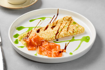 Elegant Salmon Omelette on Minimalist Plate with Artful Sauces