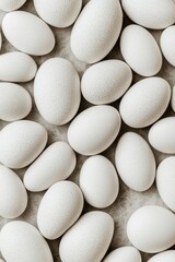 Many speckled white eggs nestled together softly