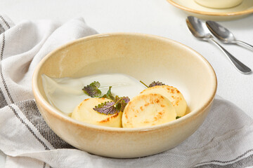 Classic Syrniki with Sour Cream in Rustic Setting Warm Tones and Soft Lighting Highlight Comforting Homemade Dessert