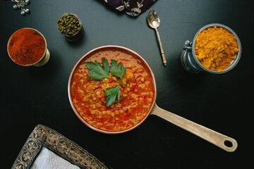 A tempting showcase of traditional Indian cuisine with a spiced lentil dish, fresh herb garnish, and aromatic rice, beautifully highlighting culinary artistry