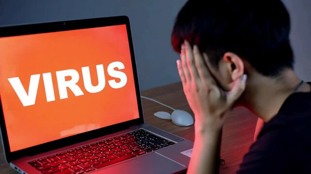 Stressed young man with virus on computer. System hacked warning alert on notebook (Laptop). Cyber attack on computer network, Virus, Spyware, Malware or Malicious software. Cyber security 4k video