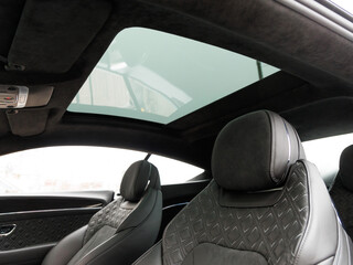 panoramic sunroof against the backdrop of luxurious leather seats in an expensive premium car
