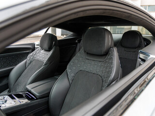 Black perforated leather car seat with macro close up isolated details. White line leather contour,...