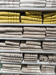colored terry towel on shelves are lined up on store shelves in stores