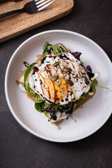 White plate of delicious food with egg and seeds top view on dark table