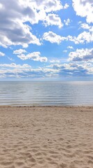Fototapeta premium Stunning Beach Scenery with a Vast Ocean and a Cloud-Filled Sky