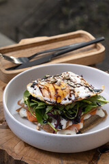 Plate of waffles and salmon with egg and seeds. Delicious and beautiful food.