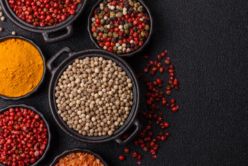 Variations of spices, allspice, turmeric, paprika, salt in ceramic bowls
