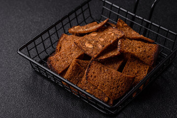 Crispy homemade brown bread chips with seeds and grains, salt, spices