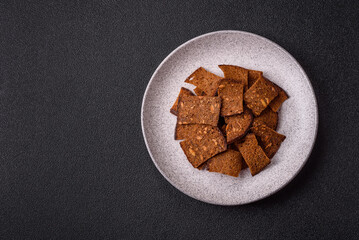 Crispy homemade brown bread chips with seeds and grains, salt, spices