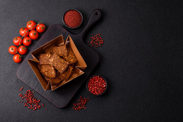 Crispy homemade brown bread chips with seeds and grains, salt, spices