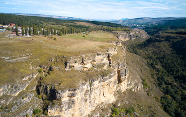 Panoramic view of a picturesque winding gorge with limestone cliffs. Shooting from a drone. Copy space.