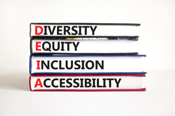Fototapeta premium DEIA symbol. Concept words DEIA diversity equity inclusion accessibility on books. Beautiful white background. Business DEIA diversity equity inclusion accessibility concept. Copy space.