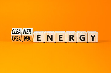 Cleaner or cheaper energy symbol. Concept words Cleaner energy Cheaper energy on beautiful wooden blocks. Beautiful orange background. Business Cleaner or cheaper energy concept. Copy space.