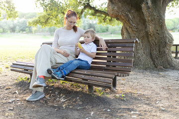 Mother and son sharing a moment on a park bench