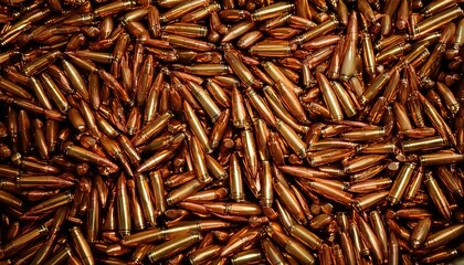 Collection of metallic bullets arranged in a dense and organized manner on a surface
