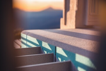 Sunset casts shadows on a textured stone surface, creating a serene and peaceful outdoor scene.