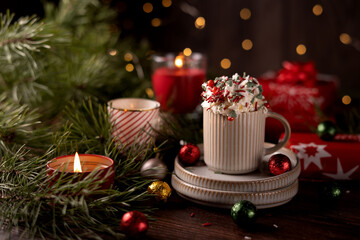 Festive Holiday Scene with Hot Chocolate, Whipped Cream, Decorations, and Warm Candlelight Embracing the Spirit of Celebration and Cozy Winter Evenings